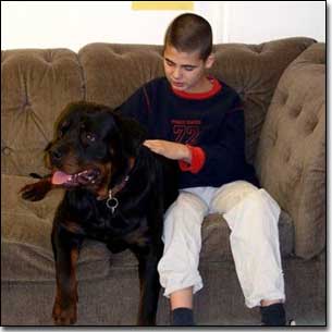 Rottie-Gabriel and KC examining Gabriel's coat on couch