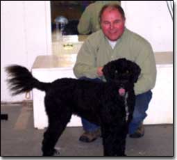 Owner and his Portugese water dog